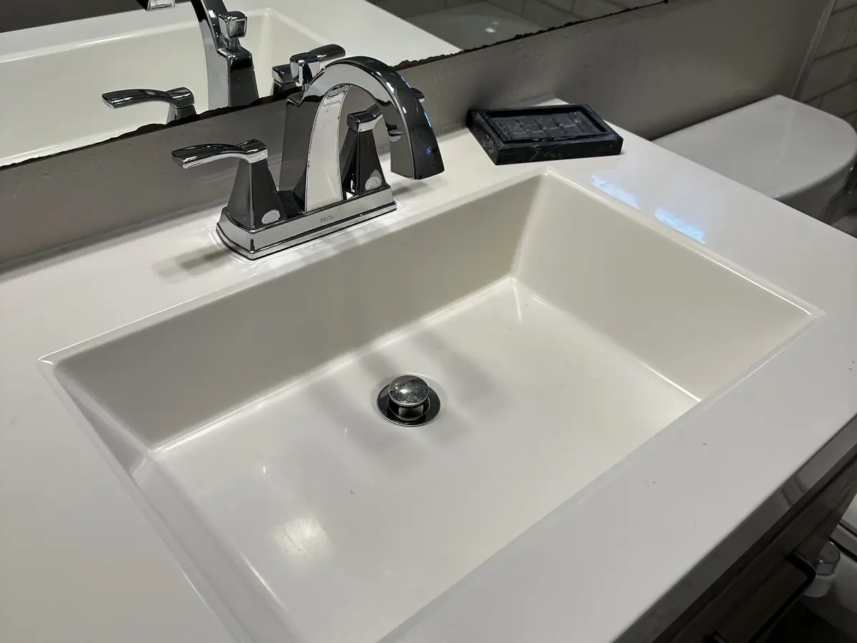 Bathroom vanity, sink and faucet clean and polished after a Cleanera visit