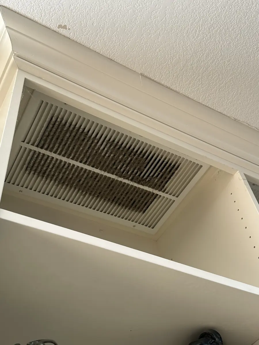 Air-return vent clogged with dust, before